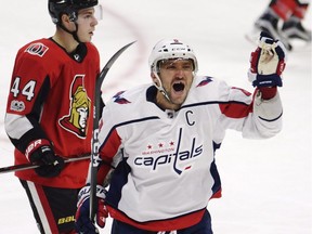 Washington Capitals left wing Alex Ovechkin celebrates his third goal of the game as Ottawa Senators centre Jean-Gabriel Pageau looks on during third period NHL hockey action in Ottawa on Thursday, October 5, 2017.