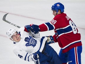 Canadiens' Brandon Davidson collides with Toronto Maple Leafs' Auston Matthews in Montreal on Saturday, Oct. 14, 2017.