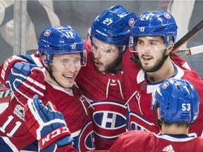 Canadiens' Alex Galchenyuk (27), celebrates with teammates Brendan Gallagher (11), Phillip Danault (24) and Victor Mete (53) after scoring against the New York Rangers during first period NHL hockey action in Montreal on Saturday, Oct. 28, 2017.