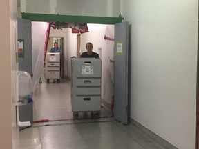 Surgical equipment is moved through a basement passageway from St-Luc Hospital to the Nouveau CHUM on Oct. 4.