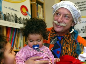 In 2004, Dr. Hunter Patch Adams holds Naji Meryme as sister Leila gets a kick out of his underwear lid at a press conference at the Montreal Children's Hospital.