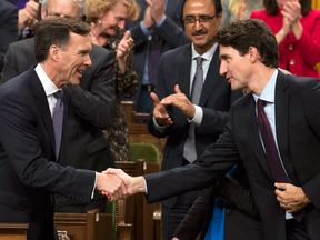 Finance Minister Bill Morneau shakes hands with Prime Minister Justin Trudeau after delivering his fall economic statement in the House of Commons, Oct.24, 2017.