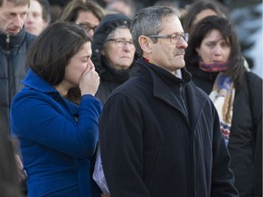 Michel LeRoux attends the funeral of his son, Thierry, along with the slain officer's fiancée, Joannie Vaillancourt (left), in Saguenay on Feb. 26, 2016.