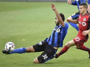 Montreal Impact defender Victor Cabrera (36) kicks the ball in front of Toronto FC forward Sebastian Giovinco (10) during MLS soccer action in Toronto on Sunday, Oct.15, 2017.