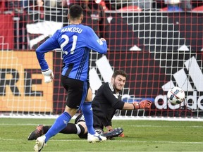 Toronto FC keeper Alex Bono makes a point blank save on Montreal Impact forward Matteo Mancosu (21) during MLS soccer action in Toronto on Sunday, Oct. 15, 2017.
