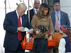 Donald Trump and Melania Trump hand out treats on Oct. 30 at the White House. It's not ghouls and ghosts Trump should fear, writes Andrew Cohen, but the spectre of special counsel Robert Mueller, who has charged three Trump associates. AP Photo/Pablo Martinez Monsivais