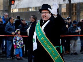 Montreal Mayor Denis Coderre shouts Happy Saint Patrick's Day to people lining Ste-Catherine street as he walks during the Saint Patrick's Day parade in Montreal on Sunday March 19, 2017.
