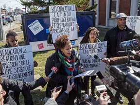 Stella Jette, centre, and other activists with the group Montreal Noir call for an end to racial profiling by Montreal police during a press conference outside SPVM Station 39 in Montreal North in Montreal on April 20, 2016.