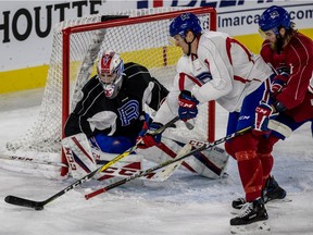 Laval Rocket forward Michael McCarron is covered in front of the net during practice at Place Bell in Laval, on Thursday, October 12, 2017.