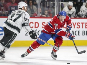 Montreal Canadiens spark plug Brendan Gallagher pushes the puck past Los Angeles Kings' Alec Martinez in Montreal on Oct. 26, 2017.