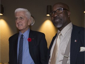 Ed Janiszewski (left) watches as results come in with veteran councillor Errol Johnson at Dollard-des-Ormeaux city hall on Sunday.