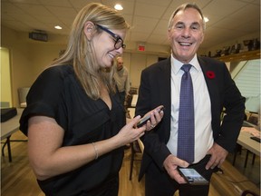 Newly elected Pointe-Claire mayor John Belvedere and his wife Sandra Hudon are all smiles as they check election results at the Pointe-Claire Curling Club on Sunday night.