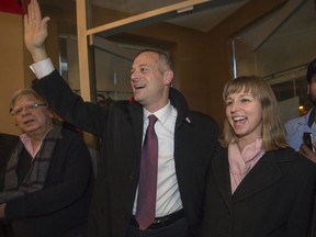 Alex Bottausci, centre, waves with wife Kim Singerman after his successful run for mayor of Dollard-des-Ormeaux.