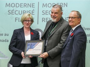 Carla Qualtrough, Minister of Public Services and Procurement, and Ron Parker, President of Shared Services Canada, right, present a plaque to Robin Hare at a press conference last Thursday, inaugurating new supercomputers at the Canadian Meteorological Centre in Dorval.  The new supercomputers were named in honour of Hare's father Dr. Kenneth Hare, and internationally famous environmentalist and meteorologist, and Harriet Brooks, Canada's first female nuclear physicist.