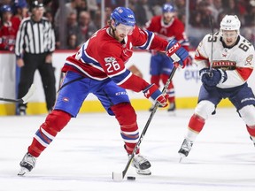 Canadiens' Jeff Petry passes the puck under pressure by Panthers' Evgenii Dadonov during second period in Montreal on Sept. 29, 2017.