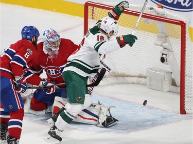 Minnesota Wild's Jason Zucker (16) scores goal on Montreal Canadiens goalie Charlie Lindgren, while Jordie Benn (8) comes in late on the play, during third period NHL action in Montreal on Thursday November 9, 2017.