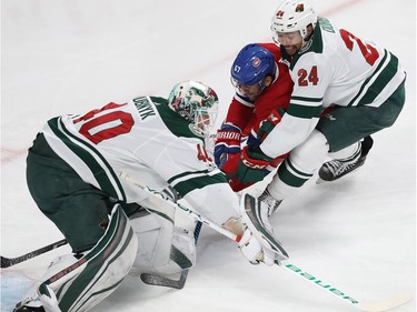 Montreal Canadiens' Max Pacioretty (67) gets in close to Minnesota Wild goalie Devan Dubnyk while being checked by Matt Dumba (24) during first period NHL action in Montreal on Thursday November 9, 2017.