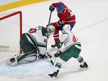 Montreal Canadiens' Paul Byron (41) tries to dig puck past Minnesota Wild goalie Devan Dubnyk, with Jared Spurgeon (46) coming in on play, during first period NHL action in Montreal on Thursday November 9, 2017.