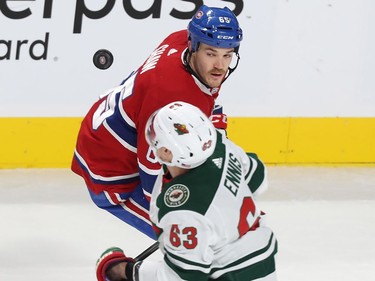 Montreal Canadiens' Andrew Shaw (65) and Minnesota Wild's Tyler Ennis (63) look up at flying puck during first period NHL action in Montreal on Thursday November 9, 2017.