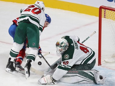 Montreal Canadiens' Brendan Gallagher (11) is pushed away from Minnesota Wild goalie Devan Dubnyk by Ryan Suter (20) during second period NHL action in Montreal on Thursday November 9, 2017.