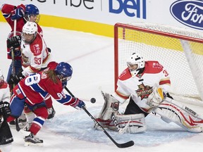 Kunlun Red Star's  goaltender Wang Yuqing makes a save against Montreal Canadiennes Kayla Tutino during second period CWHL hockey action in Montreal on Saturday, Nov. 11, 2017.