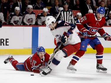 Montreal Canadiens right wing Brendan Gallagher grimaces as he hits the ice while Columbus Blue Jackets right wing Josh Anderson takes control of the puck during NHL action in Montreal on Tuesday November 14, 2017. Montreal Canadiens defenceman Joe Morrow looks on.