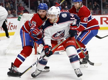 Montreal Canadiens defenceman Karl Alzner grimaces as he tries to tie up Columbus Blue Jackets Jordan Schroder during NHL action in Montreal on Tuesday November 14, 2017.