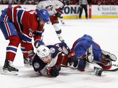 Columbus Blue Jackets centre Tyler Motte gets sent to the ice by Montreal Canadiens defenceman Jordie Benn, left, and Montreal Canadiens defenceman Shea Weber during NHL action in Montreal on Tuesday November 14, 2017.