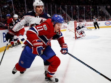 Montreal Canadiens right wing Brendan Gallagher struggles to shake off Columbus Blue Jackets centre Boone Jenner during NHL action in Montreal on Tuesday November 14, 2017.