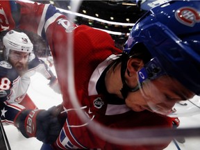 Canadiens forward Charles Hudon gets shoved into the boards by Columbus Blue Jackets defenseman David Savard during game at the Bell Centre on Nov. 14, 2017. The Blue Jackets won the game 2-1 in overtime.