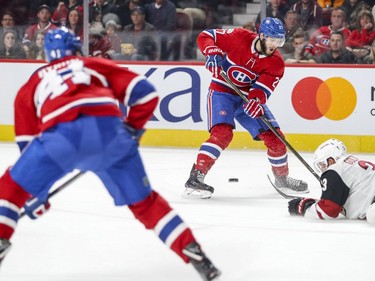 Montreal Canadiens Alex Galchenyuk, right, slides a pass past Arizona Coyotes Alex Goligoski to teammate Paul Byron during first period of National Hockey League game in Montreal Thursday November 16, 2017. Byron scored on the shot after receiving the pass for the Canadiens' second goal of the game.