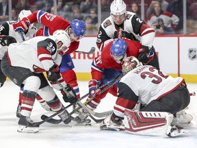 Montreal Canadiens Max Pacioretty, rear left, and Brendan Gallagher battle for the puck with Arizona Coyotes Alex Goligoski, 33, Luke Schenn and goalie Antti Raanta during third period of National Hockey League game in Montreal Thursday November 16, 2017.