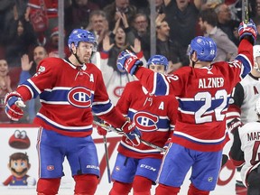 Montreal Canadiens' Shea Weber, left, celebrates his goal against the Arizona Coyotes with team-mates Karl Alzner and Tomas Plekanec during second period in Montreal on Nov. 16, 2017.