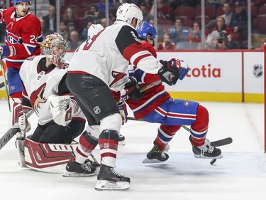 Montreal Canadiens Andrew Shaw falls to the ice while being checked in the crease of Arizona Coyotes goalie Antti Raanta, left, by defenceman Alex Goligoski as the puck heads into the net during third period of National Hockey League game in Montreal Thursday November 16, 2017. After review it was ruled that Shaw kicked the puck into the net.