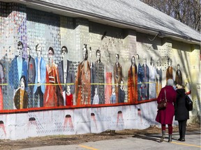 A couple of women look at the Canada 150 mural in painted on the side of the Stephen F. Shaar Community Centre in Hudson last Friday.