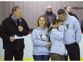 Hockey West Island President Andy Brookman, left, looks on as parents Jay and Julie and sister Allison of Tristan Morrissette-Perkins attend a jersey retirement ceremony for Tristan at the Dorval arena on Sunday.