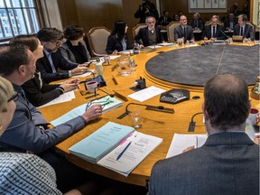 Mayor Valérie Plante, leaning forward at left, attends her administration's first executive-committee meeting at city hall on Wednesday.