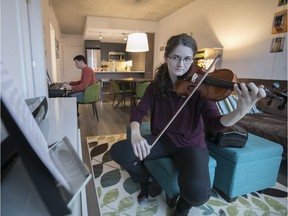 Kira McLean and Michael Belyea practise their musical instruments in their open concept condo in Griffintown.