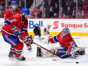 Goaltender Charlie Lindgren of the Montreal Canadiens reaches behind him as teammate Jordie Benn picks up the rebound against the Vegas Golden Knights at the Bell Centre on Nov. 7, 2017, in Montreal, Quebec, Canada.