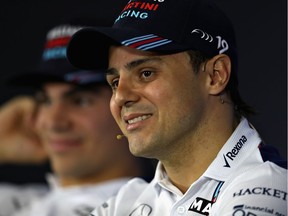 Felipe Massa, with teammate Lance Stroll looking on, takes questions during a drivers' news conference ahead of this weekend's Brazilian Grand Prix.
