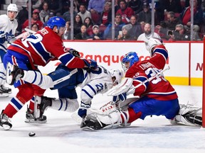 Canadiens' Karl Alzner takes out Leafs' Connor Brown near goaltender Charlie Lindgren at the Bell Centre on Saturday, Nov. 18, 2017, in Montreal.