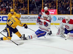 Brandon Davidson (#88) of the Montreal Canadiens slides in front of goalie Antti Niemi (#37) as he makes a save on a shot by Viktor Arvidsson (#33) of the Nashville Predators during the first period at Bridgestone Arena on November 22, 2017 in Nashville, Tennessee.