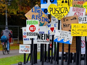 A picture taken on November 6, 2017 shows a installation made out of placards reading slogans at the Rheinaue park during the COP23 United Nations Climate Change Conference in Bonn, Germany.