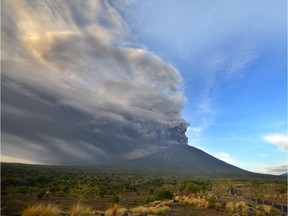 General view of Mount Agung during an eruption seen from Kubu sub-district in Karangasem Regency, on Indonesia's resort island of Bali on November 26, 2017.  Mount Agung belched smoke as high as 1,500 metres above its summit, sparking an exodus from settlements near the mountain.