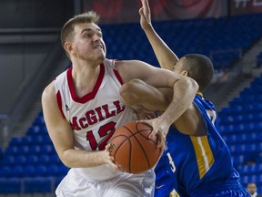 McGill University Redmen's Noah Daoust battles UBC Thunderbirds player for position during the consolation round of the CIS Final 8 Championship at the Doug Mitchell Arena at UBC in Vancouve on March, 18, 2016.