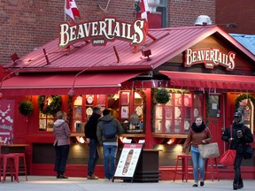 People line up to order outside a BeaverTails stand in Ottawa's Byward Market on Thursday, Nov. 23, 2017. A trademark flap over a deep-fried Canadian pastry has reached a sweet conclusion.