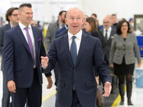 Bombardier president and CEO Alain Bellemare smiles as he walks through a finishing plant in Montreal on Friday, Nov. 17, 2017.