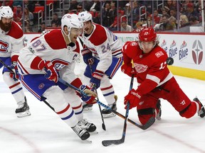 Montreal Canadiens left wing Max Pacioretty (67) and Detroit Red Wings left wing David Booth (17) battle for the puck in the second period of an NHL hockey game Thursday, Nov. 30, 2017, in Detroit.