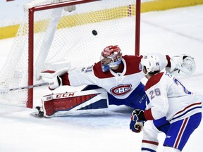 Montreal Canadiens' Jeff Petry watches a goal by Minnesota Wild left wing Tyler Ennis get past Canadiens goalie Carey Price during the first period Nov. 2, 2017, in St. Paul, Minn.