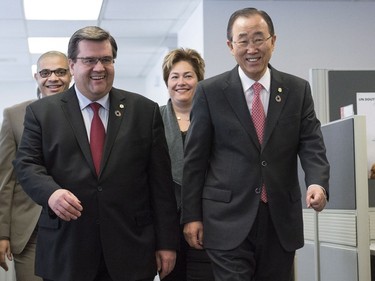 Montreal Mayor Denis Coderre, left, and United Nations Secretary General Ban Ki-moon talk as they tour an anti-radicalization centre in Montreal, Saturday, February 13, 2016.